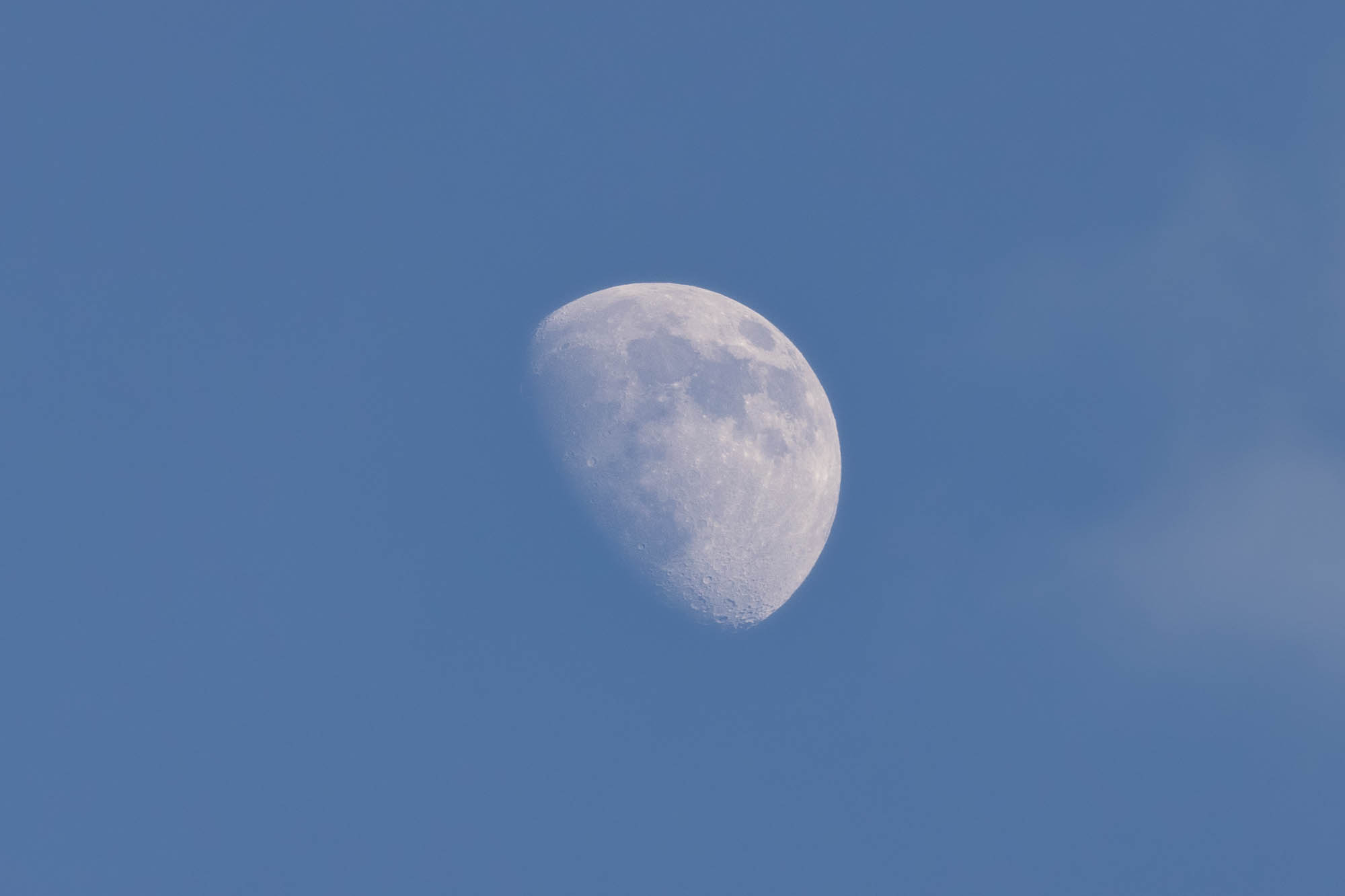 Moon in the blue sky. 69.5% illuminated